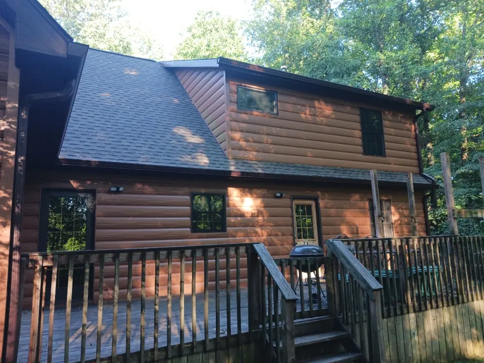 Completed gutter and siding upgrade on a woodland home