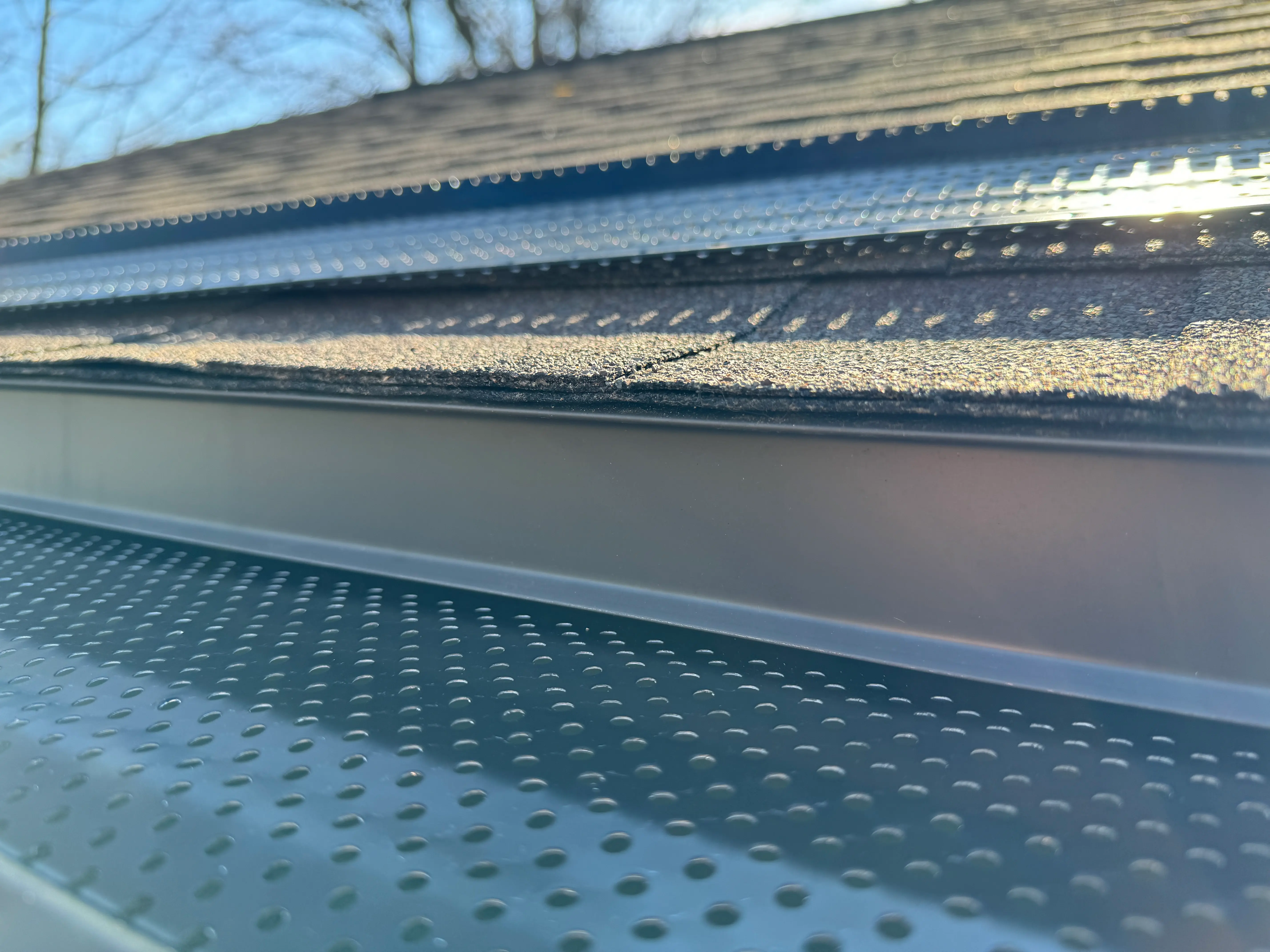 Close-up of a professionally installed perforated gutter guard