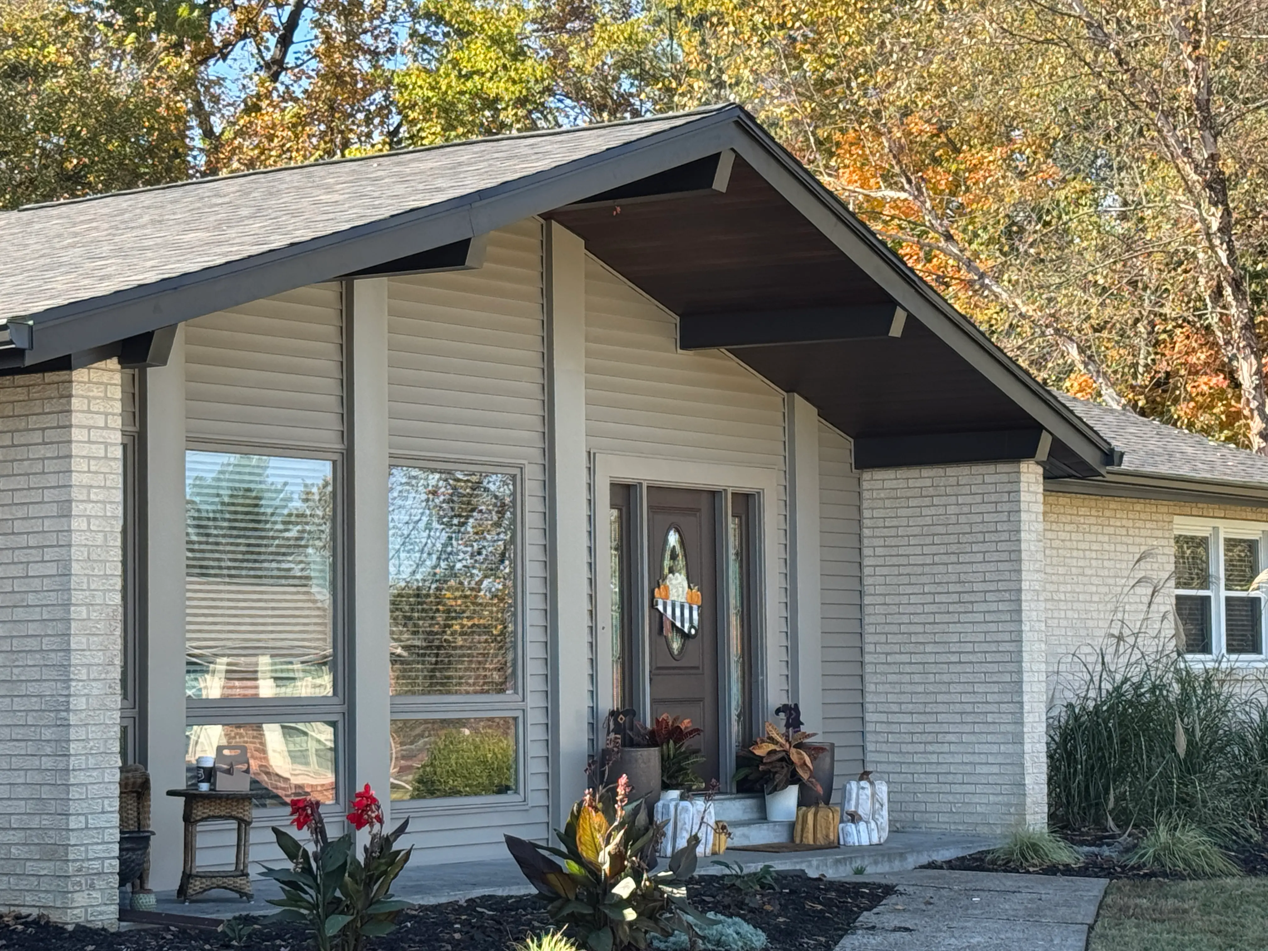 Home exterior window and door upgraded with clean white vinyl frames and custom metal wrap trim